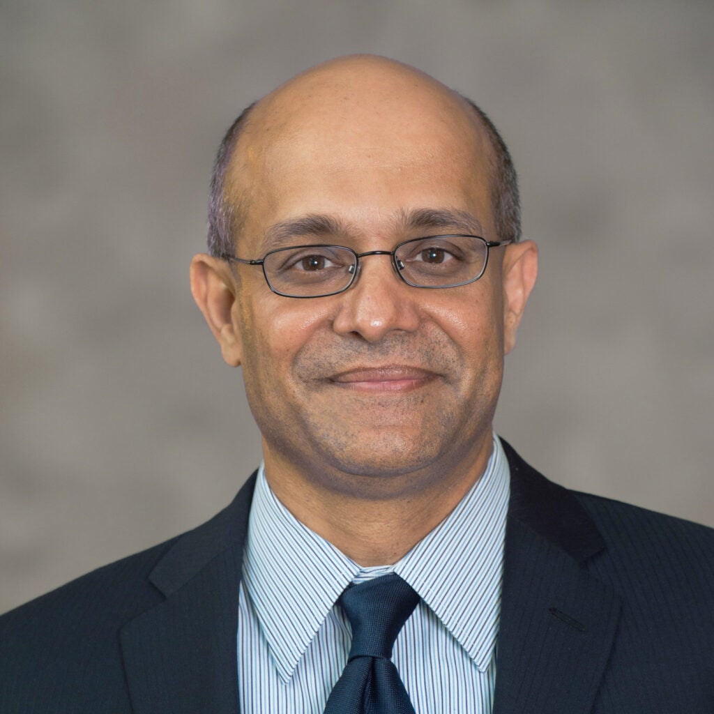 A headshot of Dean Paul Almeida.